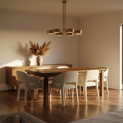 Lacrima brass chandelier hanging in a modern living room with neutral sofa