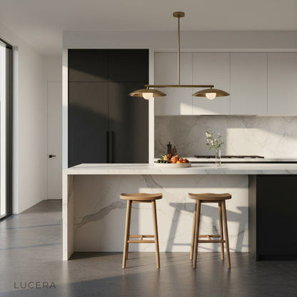 Sculptural disc pendant light hanging over a kitchen island with warm ambient daylight