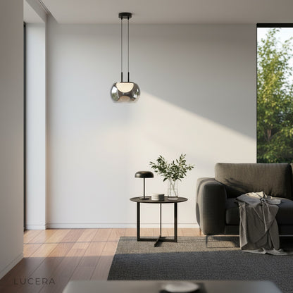Gareth pendant light over a reading nook with warm accent lighting and plants