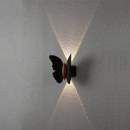 close-up of black iron butterfly wing detail on wall lamp