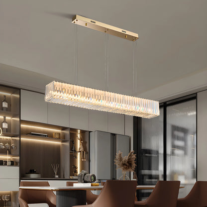 Ivar rectangular crystal LED chandelier glowing over a modern dining table in a bright living room