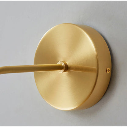 gold finish variant of Jaen LED wall light mounted on neutral wall in bright interior