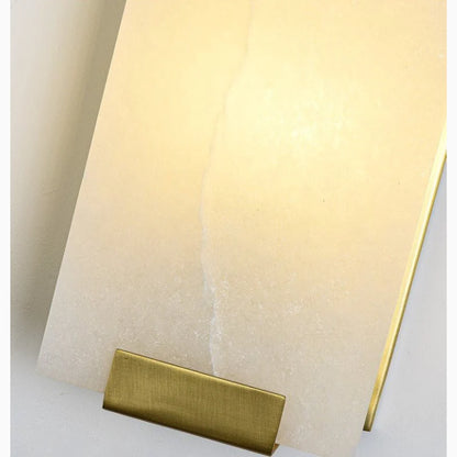 copper-marble LED wall lamp illuminating cozy bedroom nightstand area