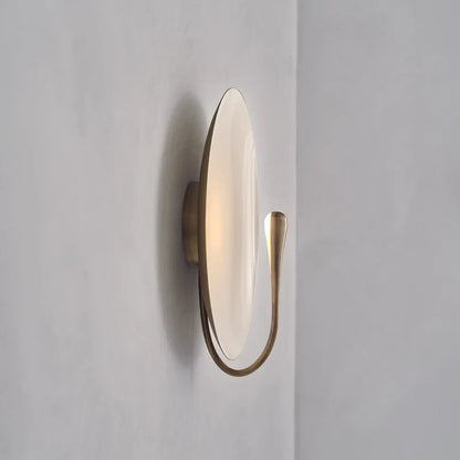 white marble wall lamp mounted on iron bracket against neutral wall