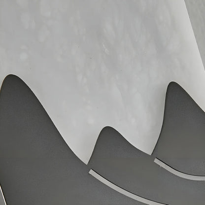 Overhead detail of stainless steel fixture and imitation marble diffuser on Axonal sconce