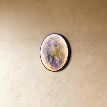 Caspian Moon Wall Lamp in a contemporary office space above a sleek desk with subtle daylight