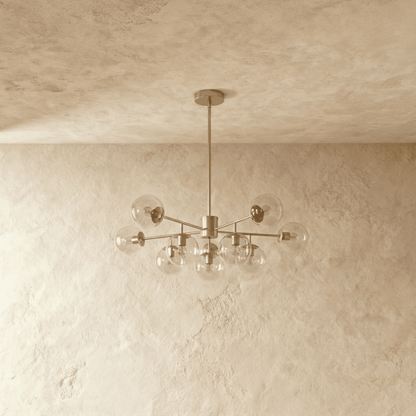 Yett chandelier front view with clear blown glass accents on neutral gray backdrop
