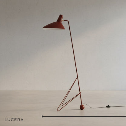 black iron angled tripod floor lamp with sleek cone shade front view