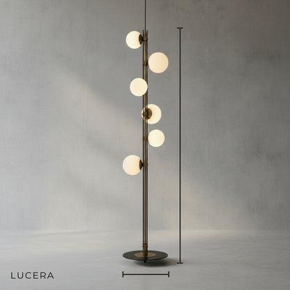 Front view of brass and black twisted metal floor lamp with globe lights in studio
