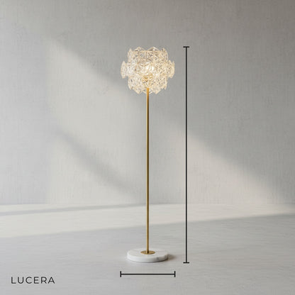 front view of crystal and marble floor lamp with polished copper stem in clean studio setting