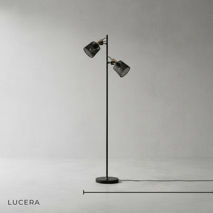 minimalist black metal floor lamp with dual heads in full view against neutral studio backdrop