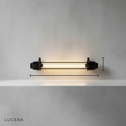 Vigrid Faulensee wall lamp side angle on clean grey background showing clear glass globe and matte black finish