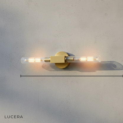 Studio shot of Ravello brass wall sconce with linear glass shade front view