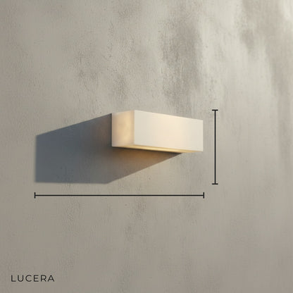 Studio view of Enjoue wall sconce showing genuine marble texture and sleek metal finish