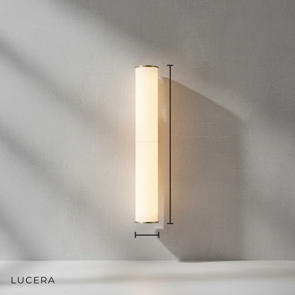 front view of tall slender Rafale marble sconce on clean neutral wall