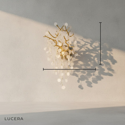 close-up of brushed brass frame and layered glass discs on poise wall lamp