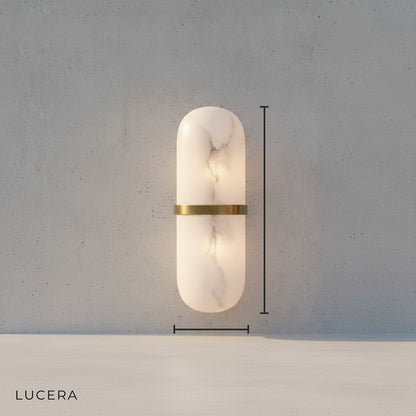 Close-up studio view of natural marble texture and copper frame on wall lamp
