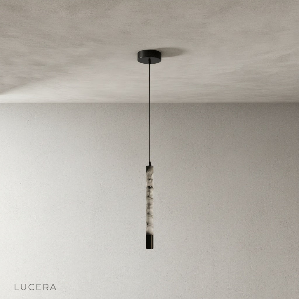 Yseult pendant light front view studio photo highlighting seamless stainless steel canopy and warm stone texture