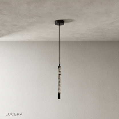 Yseult pendant light front view studio photo highlighting seamless stainless steel canopy and warm stone texture