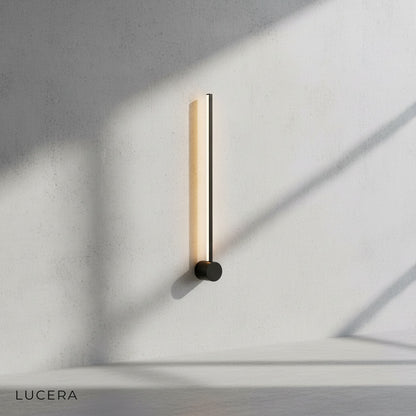minimalist black LED wall lamp mounted on clean white studio wall