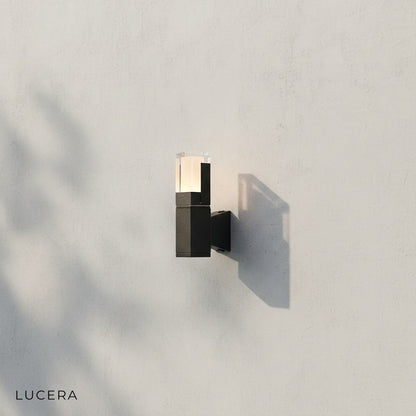 front view of Merle LED wall sconce mounted on clean white studio wall