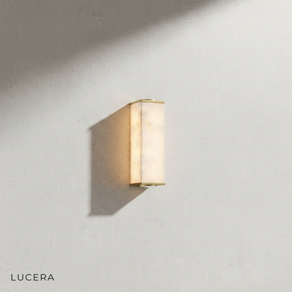 Ultime marble wall lamp angled view showing slim vertical silhouette and warm LED glow