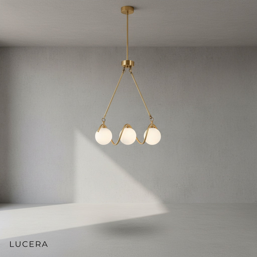 Close-up of copper metal frame and gold glass shade on Verdandi chandelier