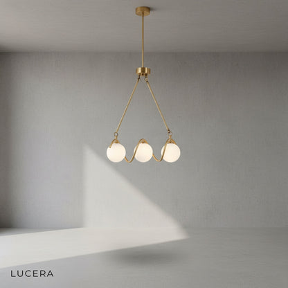 Close-up of copper metal frame and gold glass shade on Verdandi chandelier