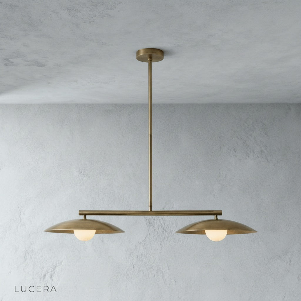 Front view of the sculptural disc pendant light in a minimalist studio setting showing its linear silhouette