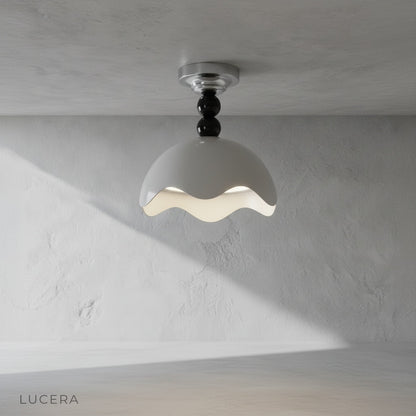 Aegis ceiling light with wave-edged shade illuminating a modern living room