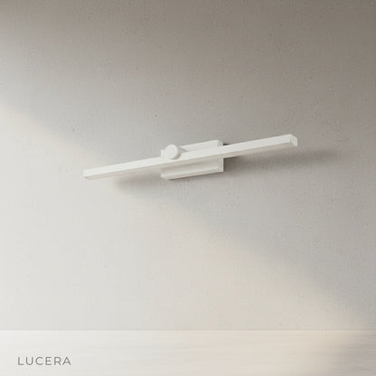 Scheele's Green Dralis wall lamp angled studio view showing iron and aluminum body