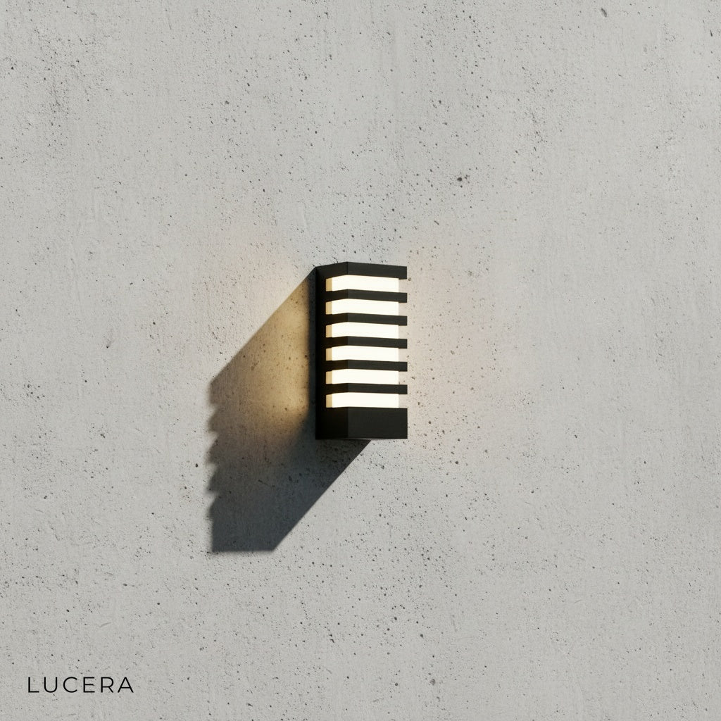 minimalist polycarbonate LED sconce front view showing frosted diffuser and dark frame