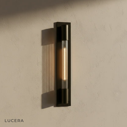 Close-up of matte black iron frame and opal glass diffuser of Verve bathroom sconce