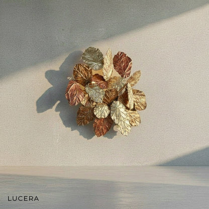 Lucera brass wall sconce styled above a wooden bedside table in a bedroom