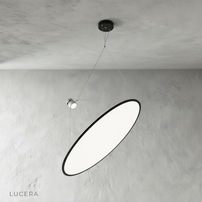 studio shot of black metal disc pendant light with white diffuser from front angle