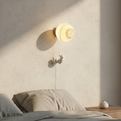 close-up of dimmable warm LED bulb inside the planet sconce's glass shade