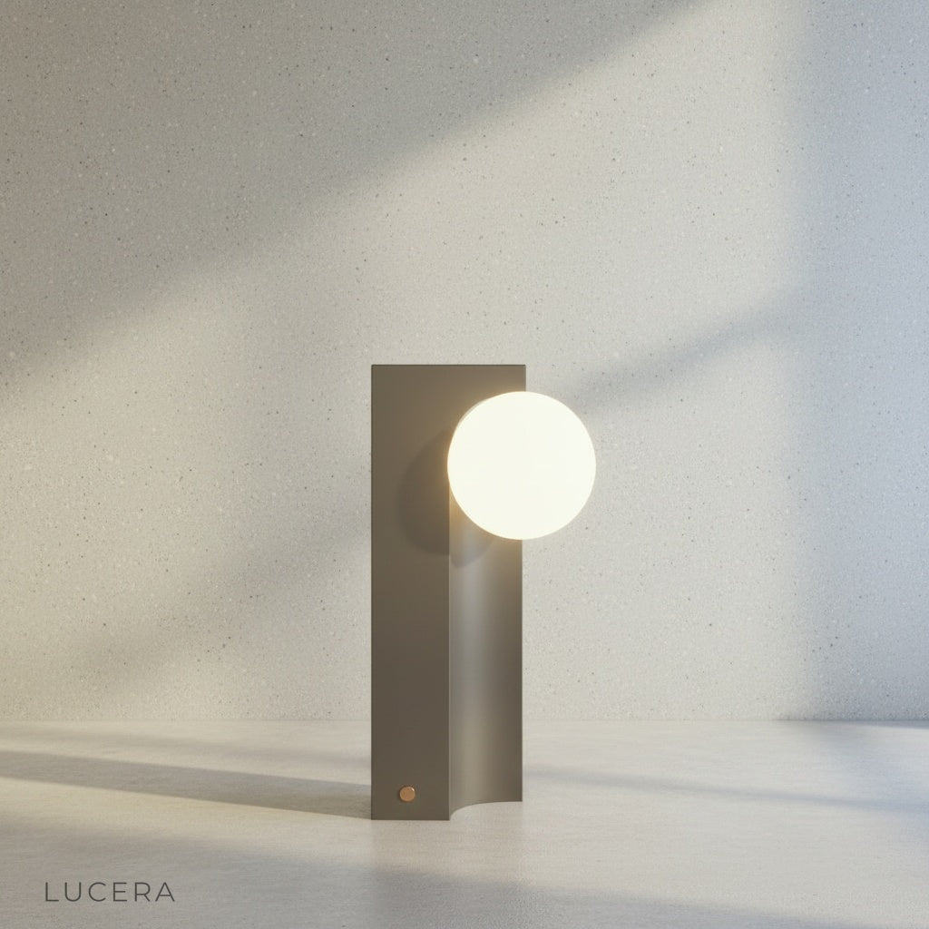 compact geometric table lamp with frosted glass shade, front view studio shot