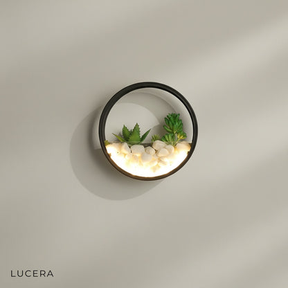 Laine outdoor sconce studio view showing imitation plants and stone texture