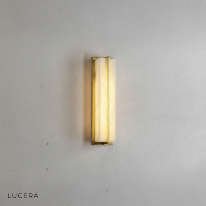 smaller size variant of the marble wall lamp in a warm brass finish