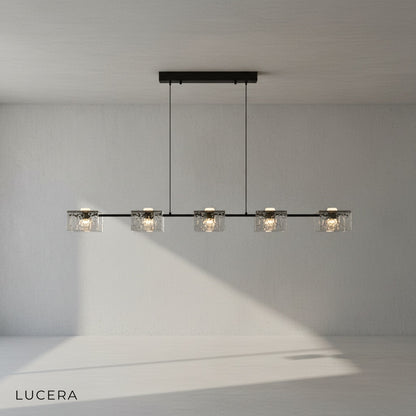Solid copper frame detail of Cinnabar chandelier with warm metallic finish and glass texture