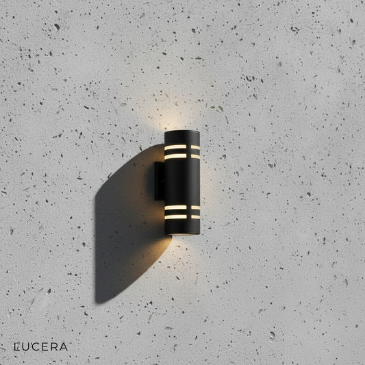 Orion smart wall light with warm LED glow mounted on brick exterior wall
