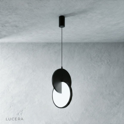 minimalist studio view of circular pendant light with brushed metal finish and soft white acrylic