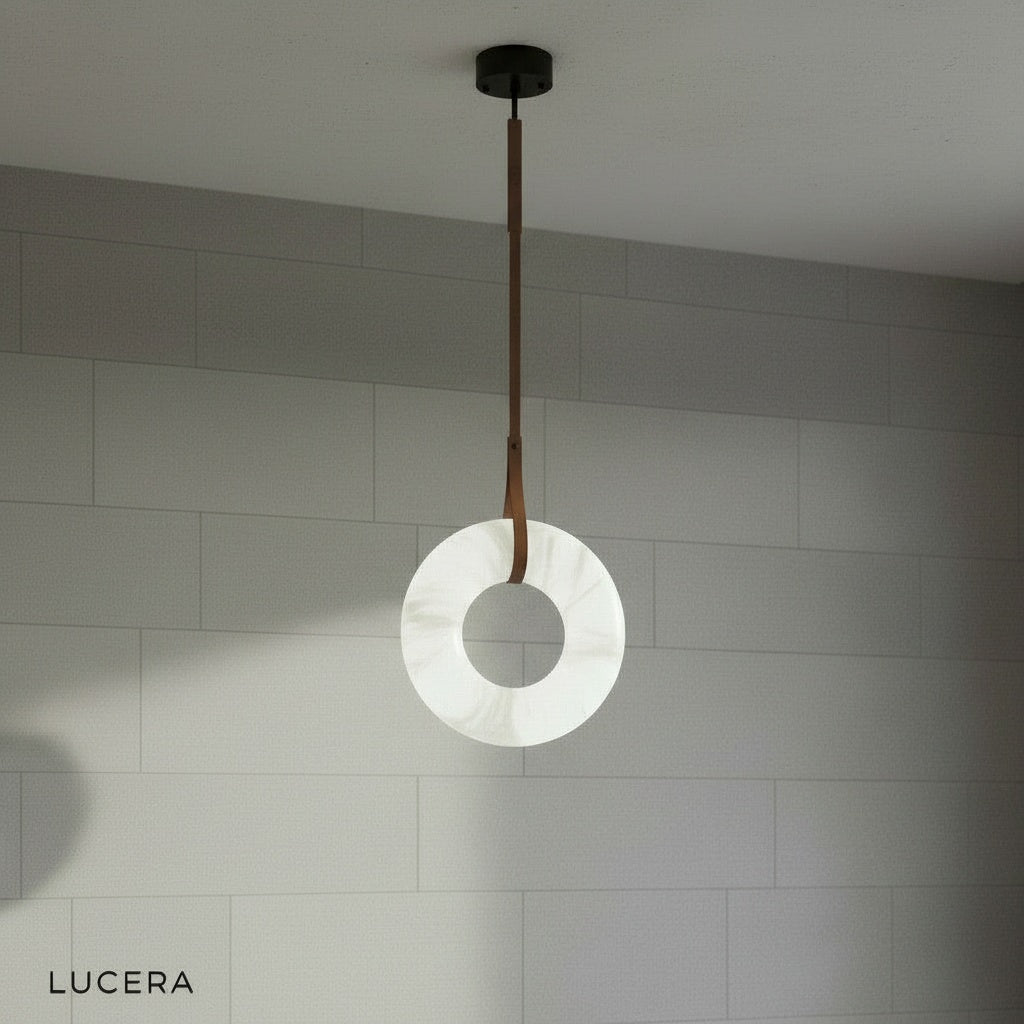 front view of Helix alabaster pendant light showing natural alabaster rings and black leather cords