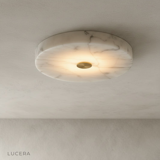 studio shot of circular alabaster marble ceiling light with copper center