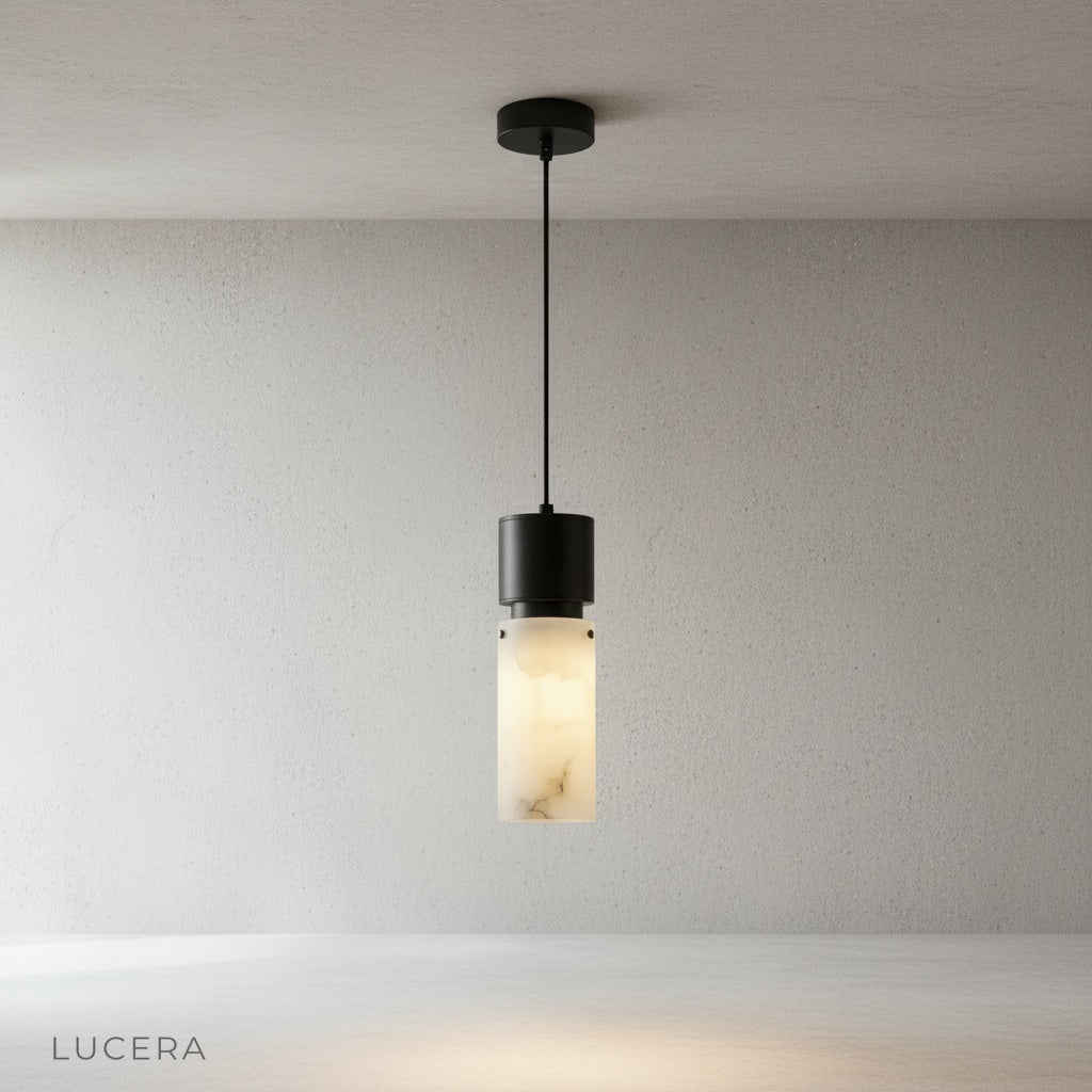 Minimalist Hematite pendant light on clean white background highlighting matte alabaster texture and brushed copper details