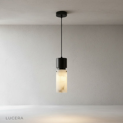 Minimalist Hematite pendant light on clean white background highlighting matte alabaster texture and brushed copper details
