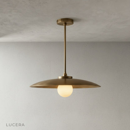 Minimalist studio view of Sylvaine pendant light showing clean brass finish
