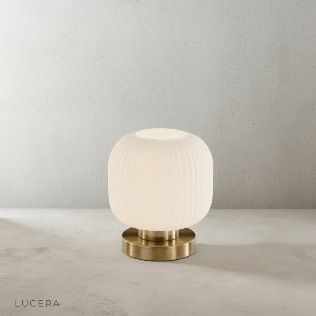 studio shot of eclat table lamp side angle with ribbed glass cylinder and polished brass