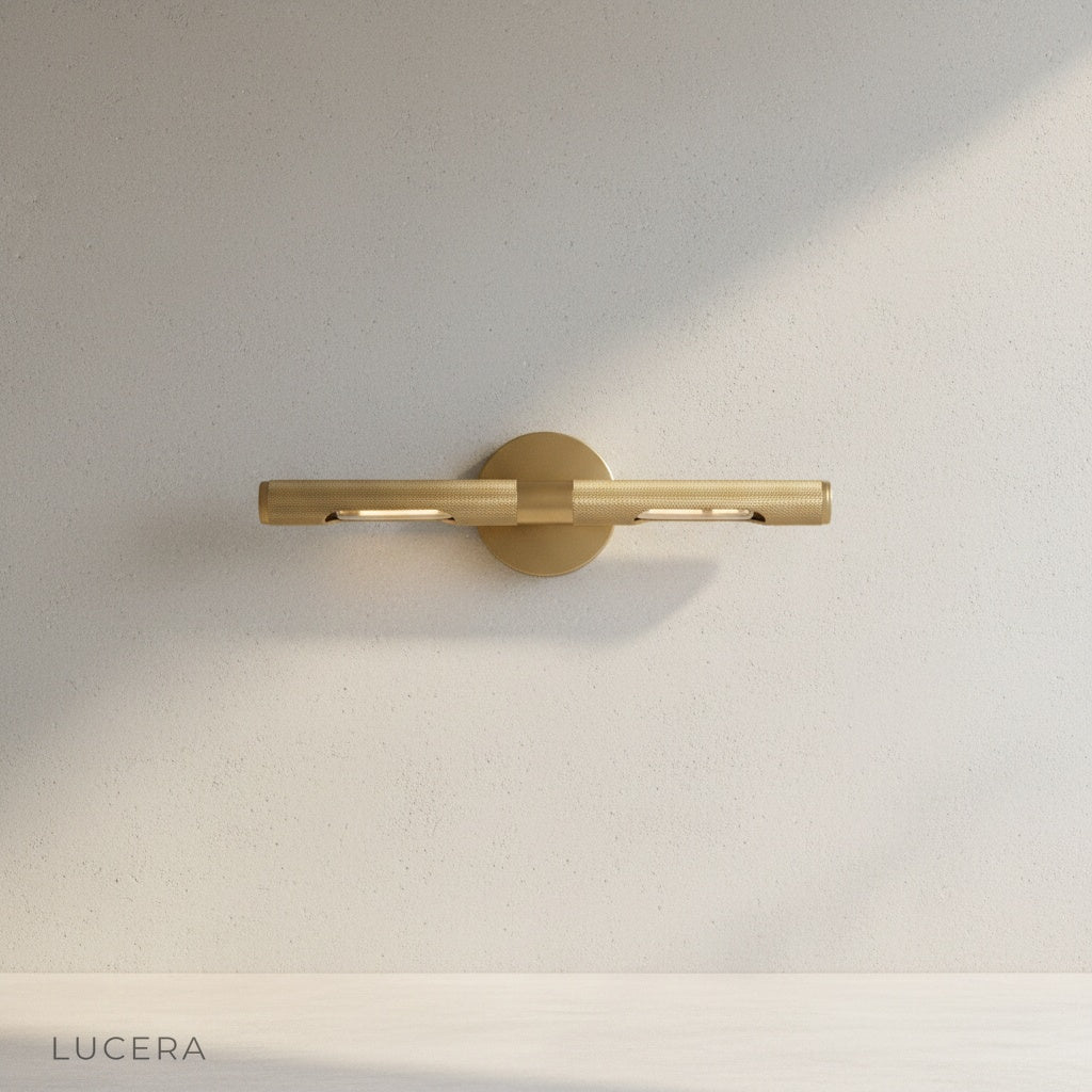 close-up of Keziah brass mirror light knurled finish and adjustable arm detail