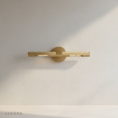 close-up of Keziah brass mirror light knurled finish and adjustable arm detail